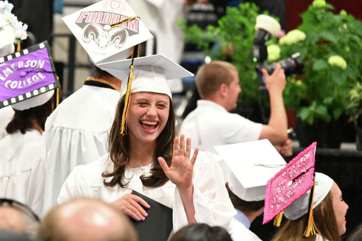 A graduate waves at the Joel Barlow High School graduation ceremony on Monday, June 20, 2022, at the O’Neill Center at Western Connecticut State University.