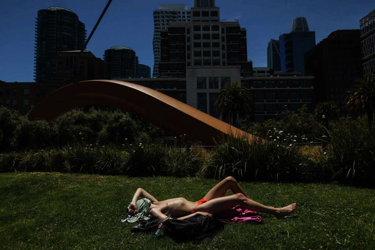 Raul Romero suntans on the Embarcadero on Friday, June 10, 2022 in San Francisco, California. Temperatures are expected to break 100 degrees in certain parts of the Bay Area.