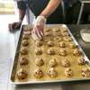 An employee of Sweet P Bakery in Westport makes cookies.