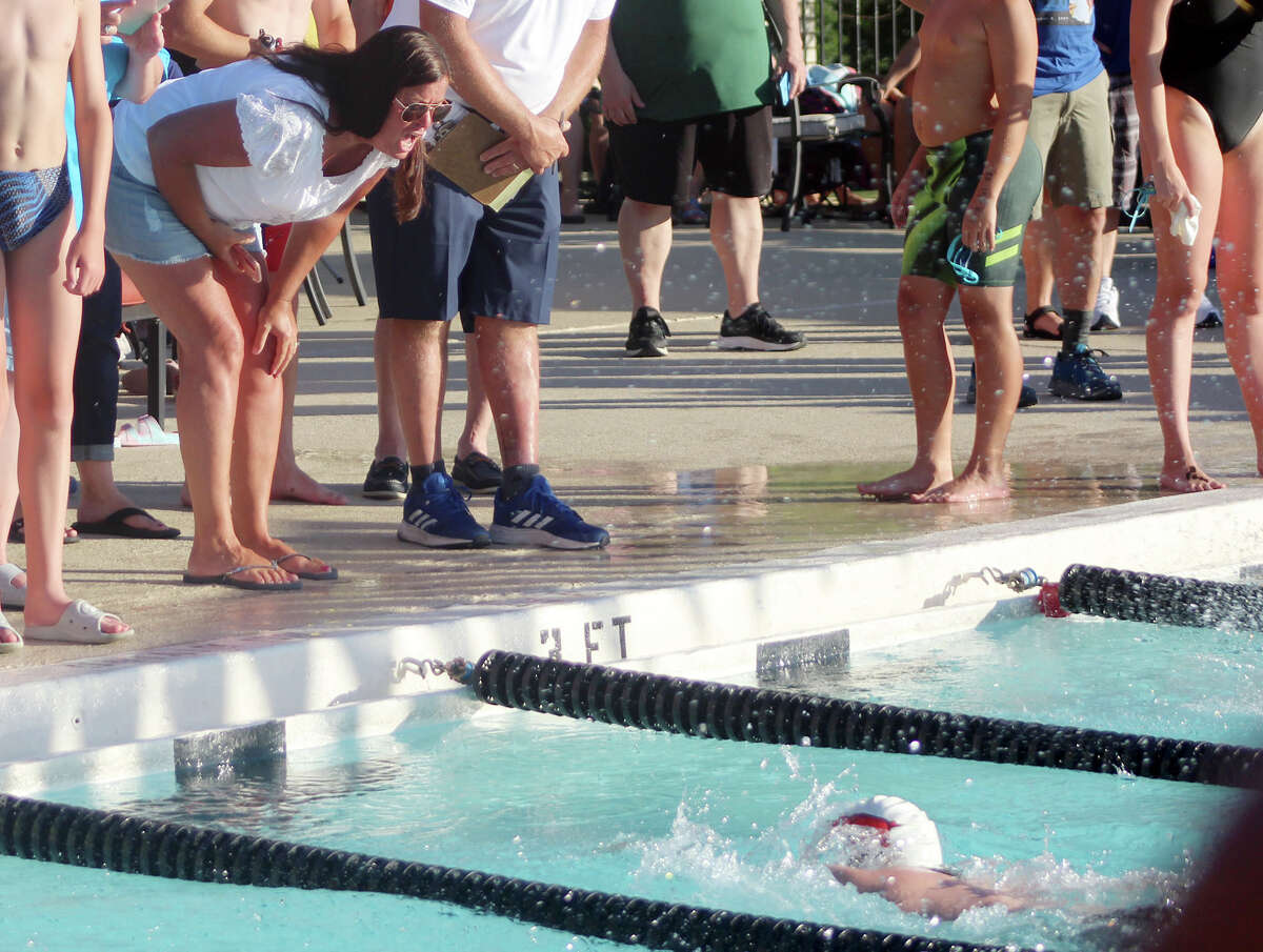 A supporter offers encouragement to a swimmer during Monday's SWISA Relays at Sunset Hills Country Club.