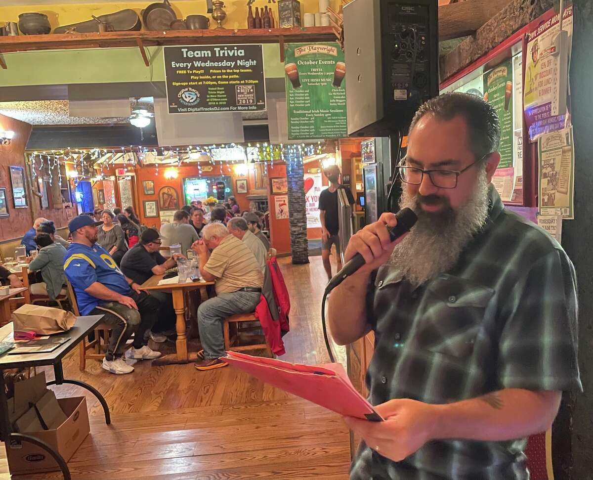 Anthony Apuzzo reads off trivia questions at The Playwright in Hamden, Conn. Oct. 13, 2021.