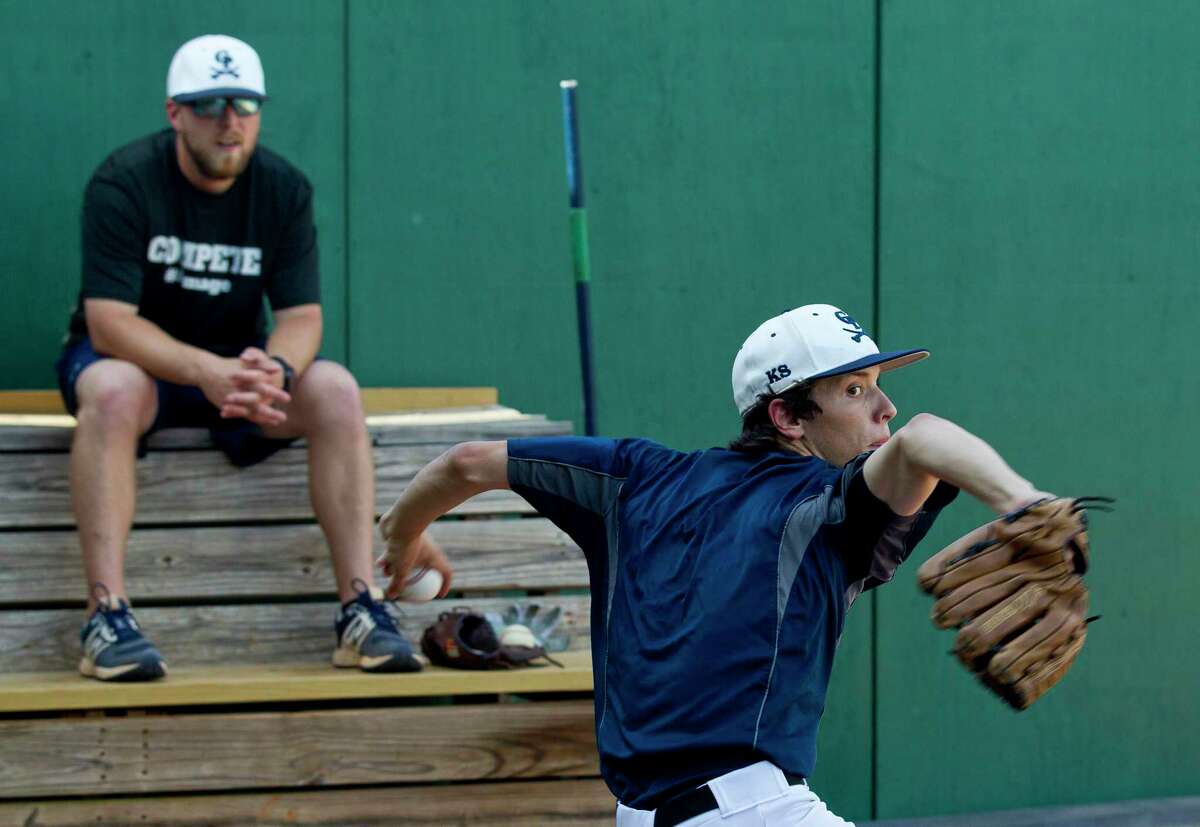 College Park switch pitcher Brandon Garza throws a bullpen session as assistant coach Brett Washburn looks on during practice, Tuesday, May 8, 2018, in The Woodlands.