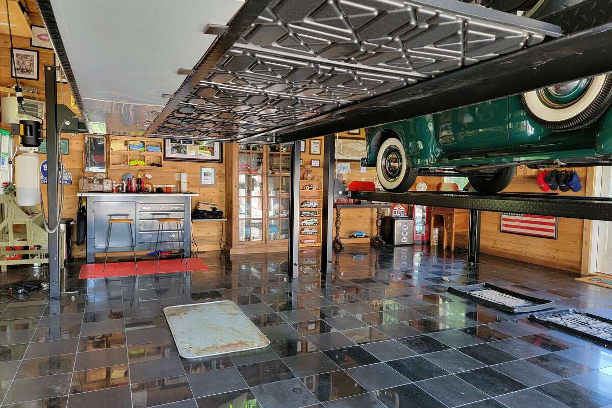 The car barn at the home on 1481 Hillside Road in Fairfield, Conn. has custom hydraulic lifts capable of lifting a 8,000 pounds, or a large steel car.