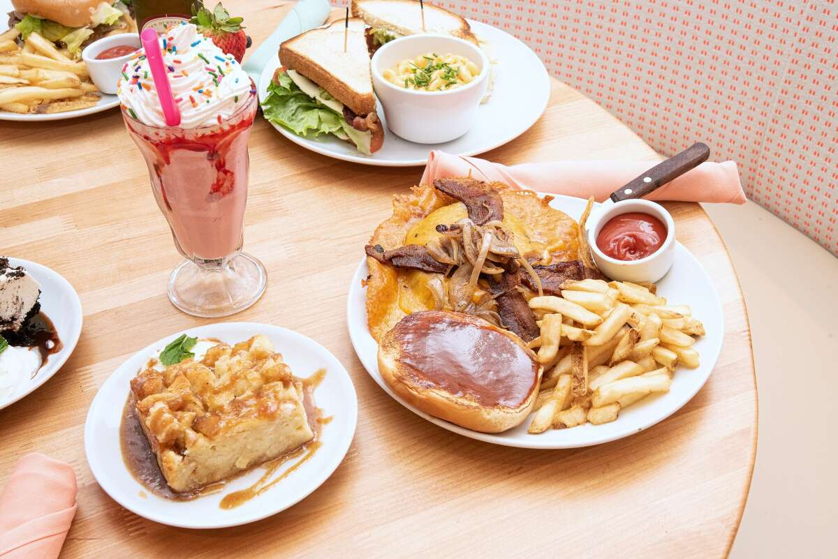 The Hunger Crush Burger is built with bacon, onions and 8 ounces of melty cheddar.