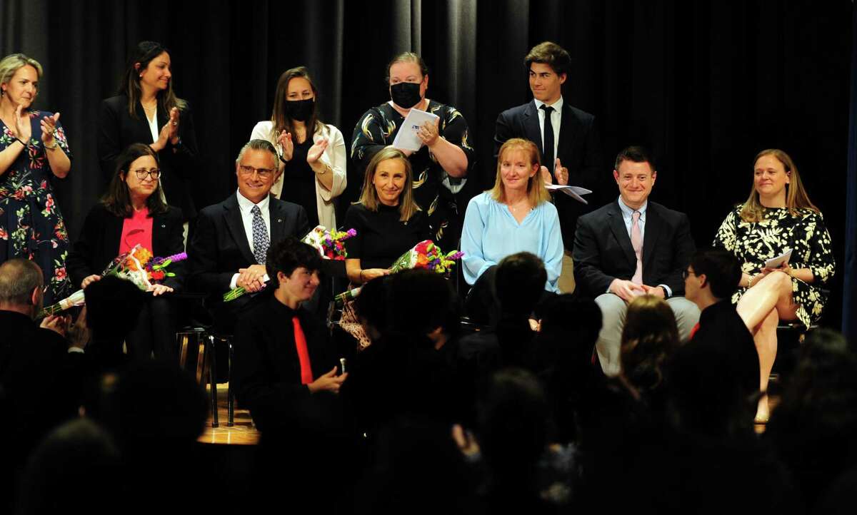 The six teachers in the Distinguished Teachers Awards Ceremony, receive applause during a ceremony at Central Middle School in Greenwich, Conn., on May 5, 2022. From left, Darcey Zygmont of North Street School, William Ronk of Riverside School, Tyler Mecozzi of Western Middle School, Alison Kistler of North Mianus School, Ryan Jones of Greenwich High and Libby Craig of the International School at Dundee’s Advanced Learning Program. Mecozzi was selected to participate in the state Department of Education’s Teacher of the Year program for 2023.
