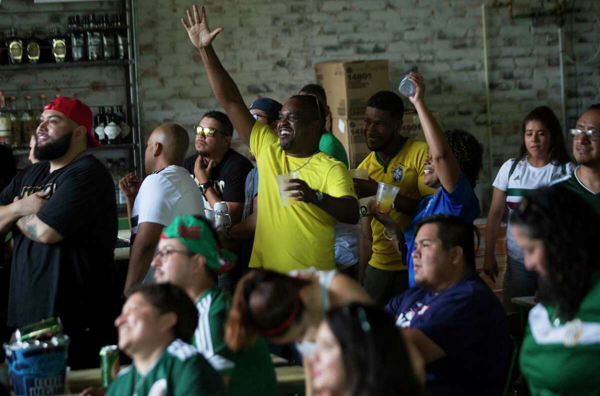 Brazil fans cheer for their team during a World Cup watch party at Pitch 25, Monday, July 2, 2018, in Houston.