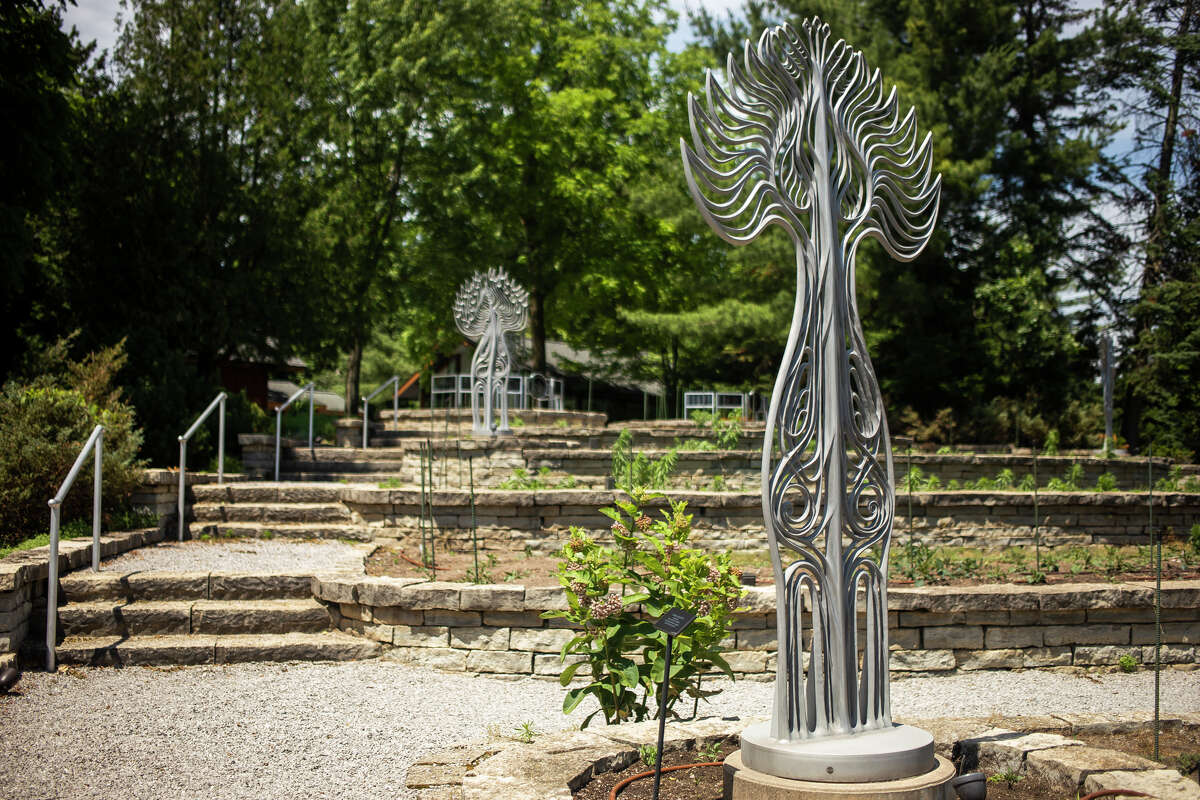 Four tall sculptures are displayed at Dahlia Hill in Midland.