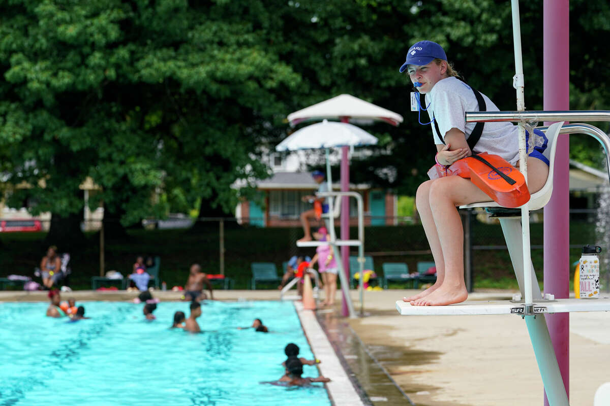 Lifeguard Elizabeth Conley keeps an eye on the swimmers. The American Lifeguard Association estimates one-third of pools in the United States are impacted by a shortage of lifeguards.