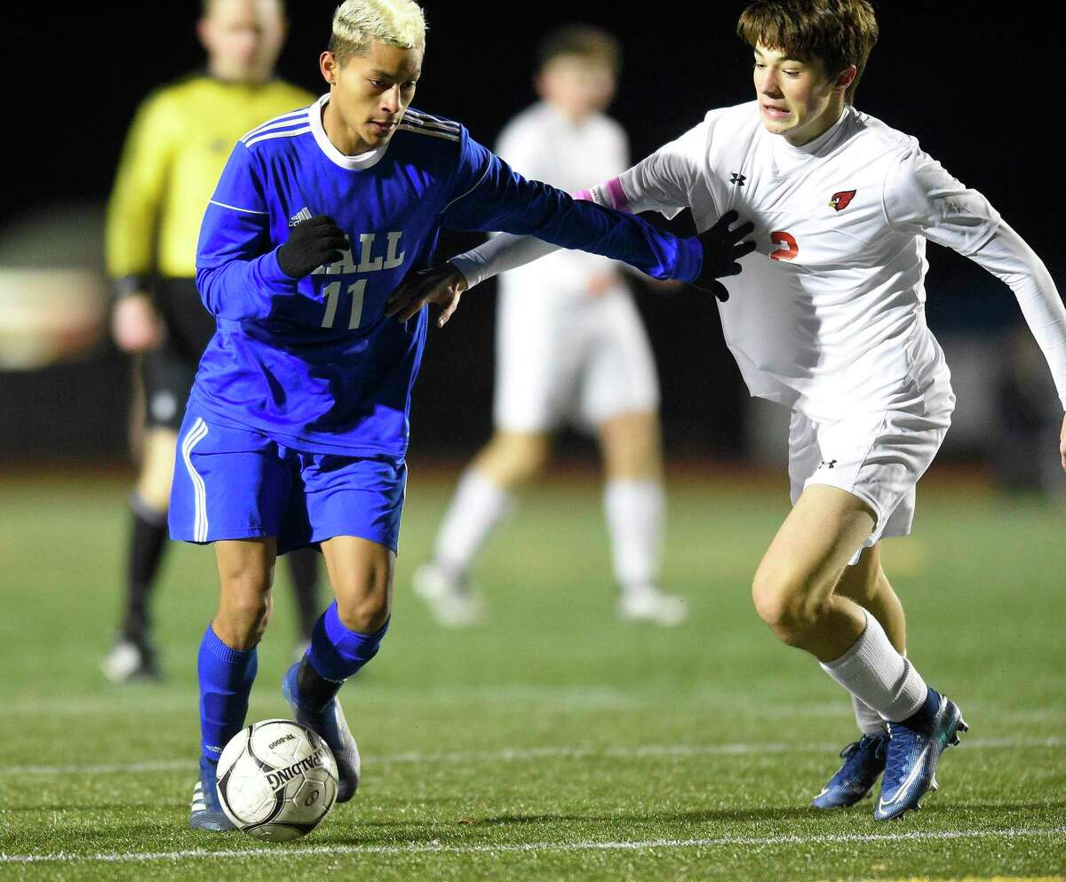 Hall’s Maximus Bunker (11) and Greenwich Maxwell Pisacreta (2) battle for the ball in the first half of a CIAC Class LL Boys Soccer State Championship at Veterans Memorial Stadium on Nov. 23, 2019 in New Britain, Conn. The two programs will meet again in the FCIAC-CCC Kick Off Classic this September.