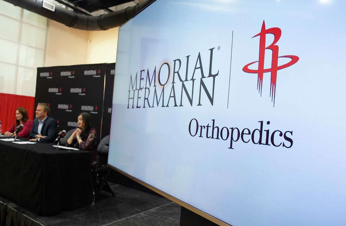 Houston Rockets announces a special partnership with Memorial Hermann Health System Tuesday, June 21, 2022, at Practice Court Toyota Center in Houston. Begain July 1, 2022, Memorial Hermann’s orthopedics and sports medicine services will be rebranded as Memorial Hermann | Rockets Orthopedics. From left: Gretchen Sheirr, Houston Rockets president of business operations; Tilman Fertitta, Houston Rockets owner; Erin Asprec, vice president and chief operating officer of Memorial Hermann Health System.