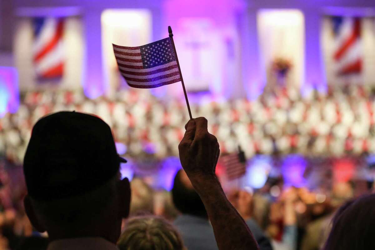 Attendees wave mini US flags during the “Celebrate America” event on Sunday, June 24, 2018, at Mims Baptist Church in Conroe. This year’s “Celebrate America” is set for this Sunday with a special patriotic worship service at 10:30 a.m. and evening activities starting at 6 p.m.