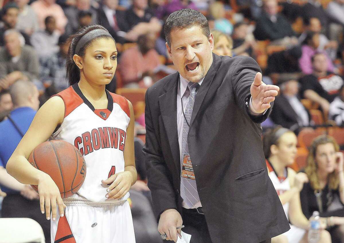 Cromwell assistant coach Sal Morello talks with senior Alexa Riley during halftime during the Class M state championship game at Mohegan Sun in 2017.