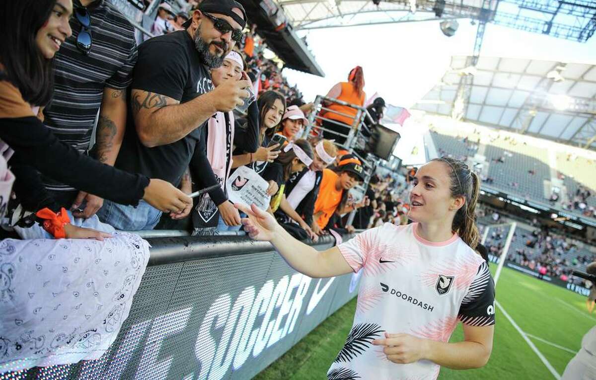 Megan Reid of Angel City FC signs autographs for fans after a game at Banc of California Stadium in May. The team is an expansion club in the NWSL this season.
