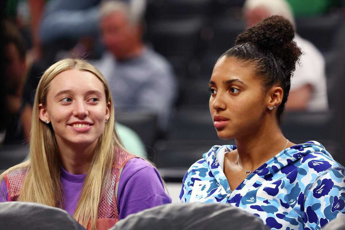 BOSTON, MASSACHUSETTS - JUNE 16: UConn women's basketball players Paige Bueckers and Azzi Fudd look on courtside in Game Six of the 2022 NBA Finals between the Golden State Warriors and the Boston Celtics at TD Garden on June 16, 2022 in Boston, Massachusetts. NOTE TO USER: User expressly acknowledges and agrees that, by downloading and/or using this photograph, User is consenting to the terms and conditions of the Getty Images License Agreement. (Photo by Elsa/Getty Images)
