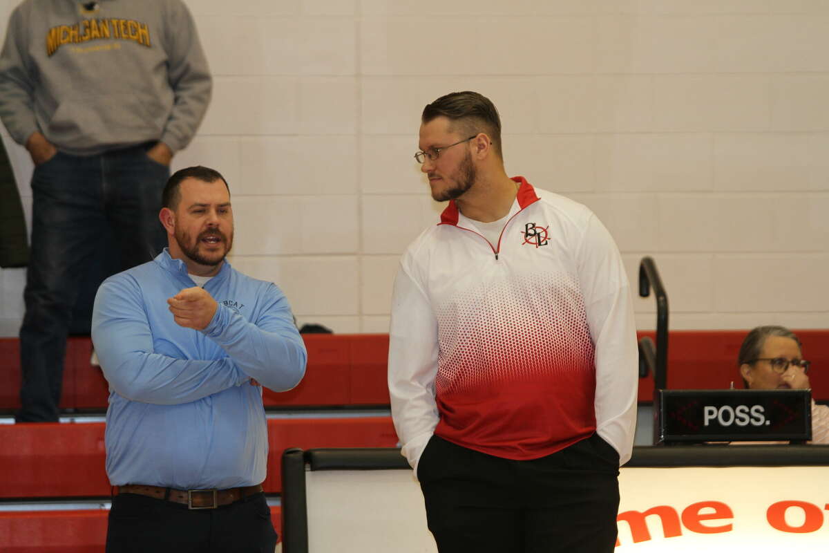 Brethren boys hoops coach JJ Randall (left) and Bear Lake coach Christian Novak (right) talk before competing against one another on Jan. 20. 