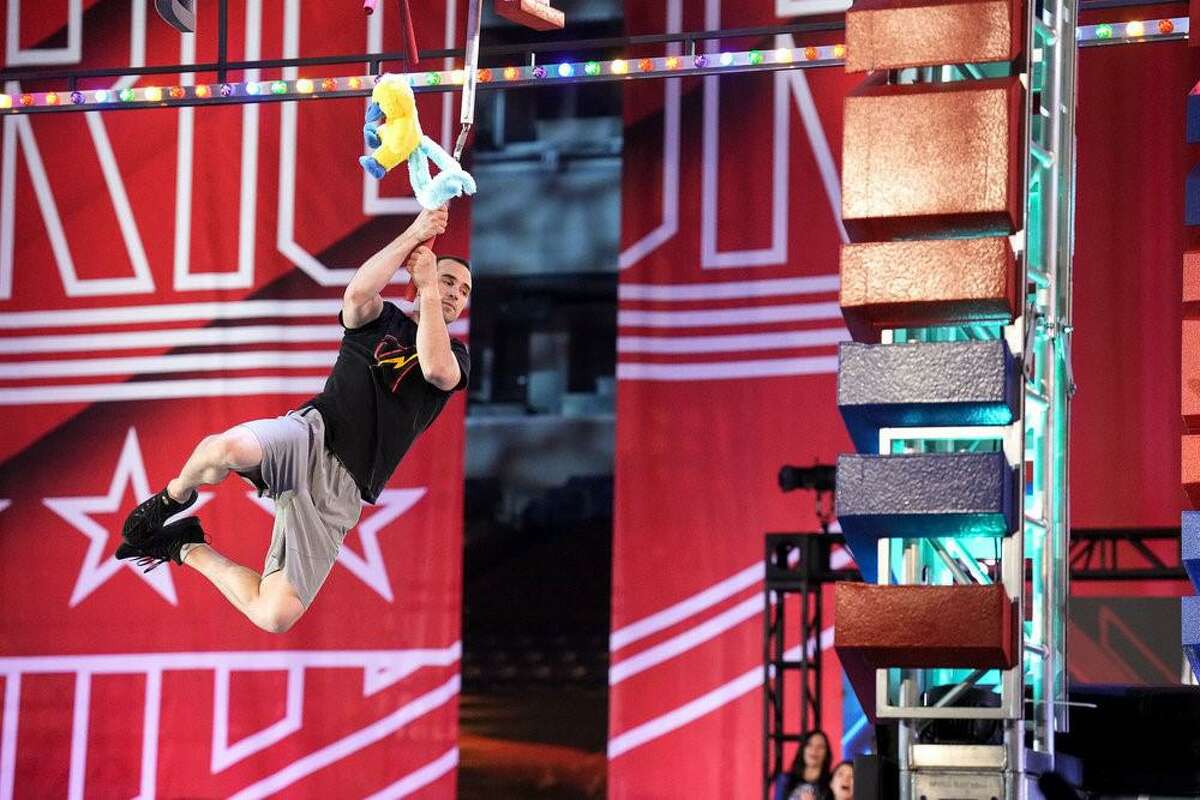 Monroe resident Joe Moravsky, swings from an obstacle course at his latest American Ninja Warrior appearance on June 13.