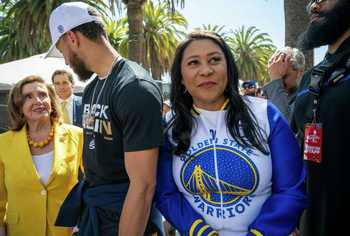 San Francisco Mayor London Breed (right), who has tested positive for the coronavirus, attends the Warriors’ victory parade Monday with House Speaker Nancy Pelosi and Warriors player Stephen Curry.