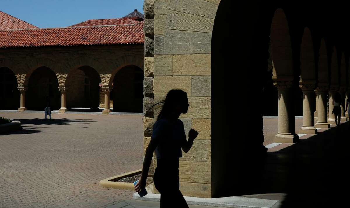 A woman leaves the main quad on the campus of Stanford University June 9, 2016 in Stanford, Calif. The power outage that forced Stanford to cancel classes for a day had no end in sight Wednesday afternoon, after Pacific Gas & Electric Co. said it could not access an area where repairs are needed to fix an equipment failure.