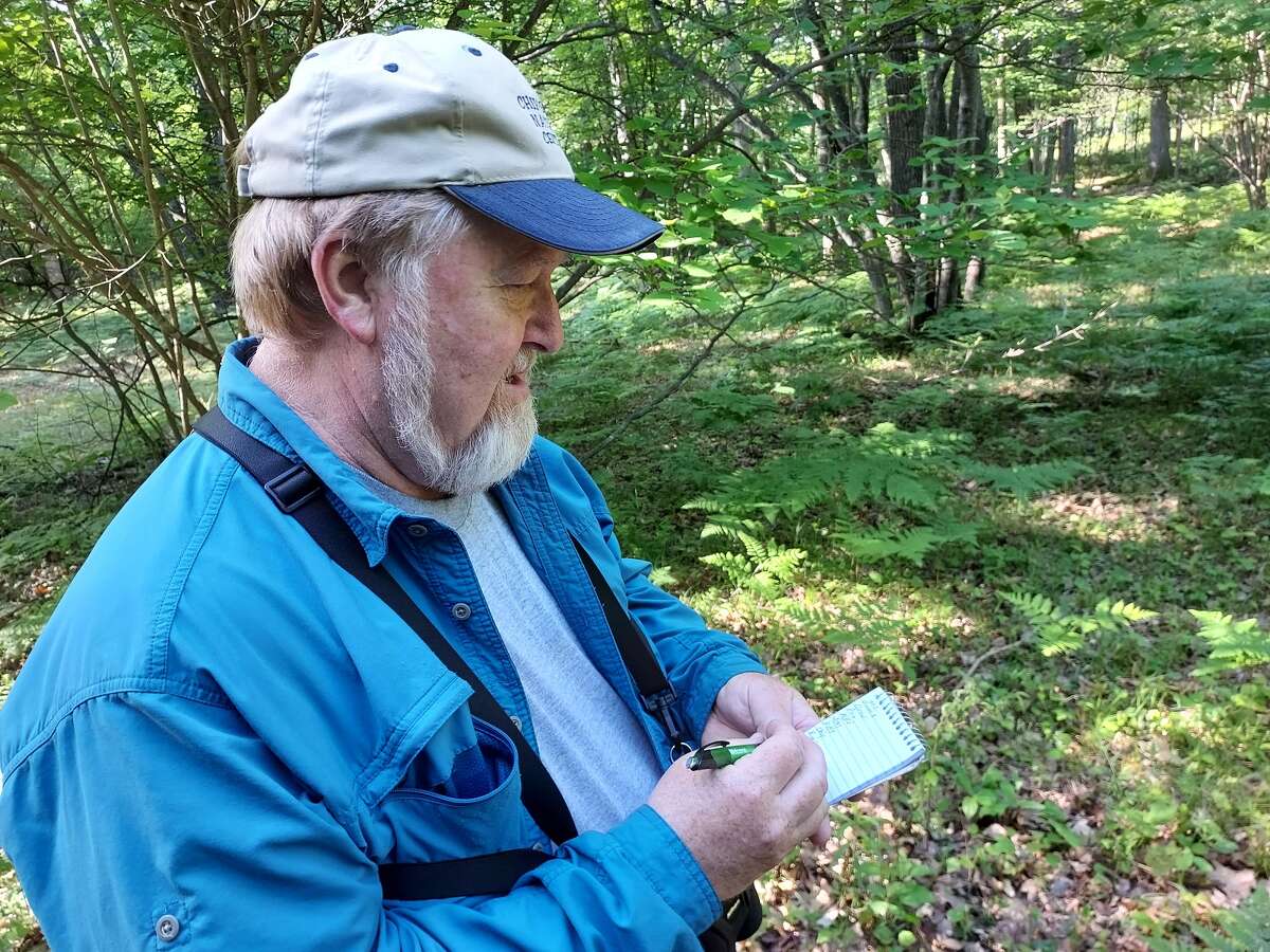 Randy Kursinsky, 64, of Lee Township, takes notes during a recent trip to Pine River Park on South Seven Mile Road. He has been a bird watcher for 50 years. 
