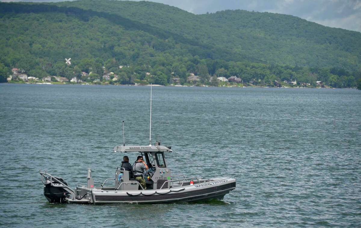 In this file photo, a patrol boat searches Candlewood Lake in Brookfield, Conn, for the body of Larry Kwokpo Chan on Thursday, June 9, 2022. His body was recovered by divers days later on June 16. The Office of the Chief Medical Examiner ruled the 24-year-old Bristol resident died from drowning, and the death has been ruled an accident.