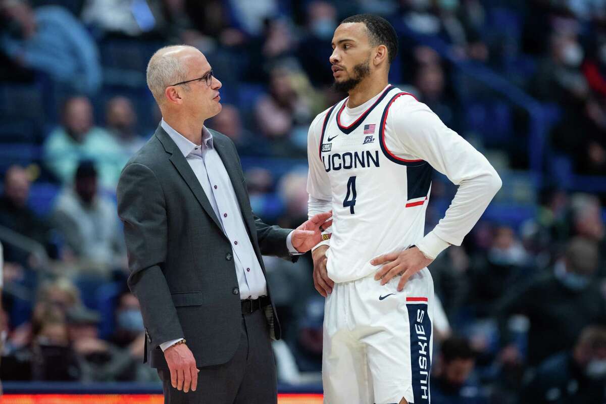 Dan Hurley (left), here speaking with former UConn forward Tyrese Martin, has added an international player from Greece to this year's UConn men's basketball roster.