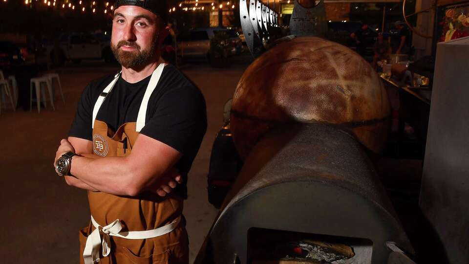 Truth BBQ pitmaster/owner Leonard Botello stands by his smoker in the parking lot of Bludorn Restaurant Thursday May 12,2022. Botello teamed up for Bludorn chef/owner Aaron Bludorn for an exclusive collaboration dinner benefitting World Central Kitchen at Bludorn Thursday, May 12,2022.