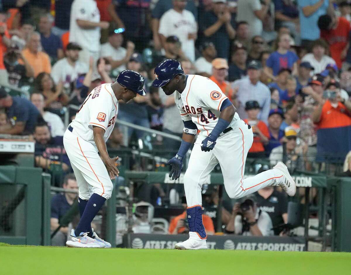 Houston Astros Yordan Alvarez (44) celebrates his home run off of New York Mets starting pitcher Carlos Carrasco with third base coach Gary Pettis (8) during the third inning of an MLB game at Minute Maid Park on Wednesday, June 22, 2022 in Houston.