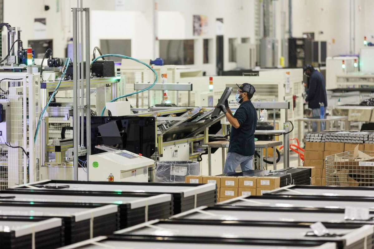 A worker tends to the production line at Mission Solar Energy’s manufacturing facility on the South Side. Mission Solar is one of the few solar panel makers in the U.S.