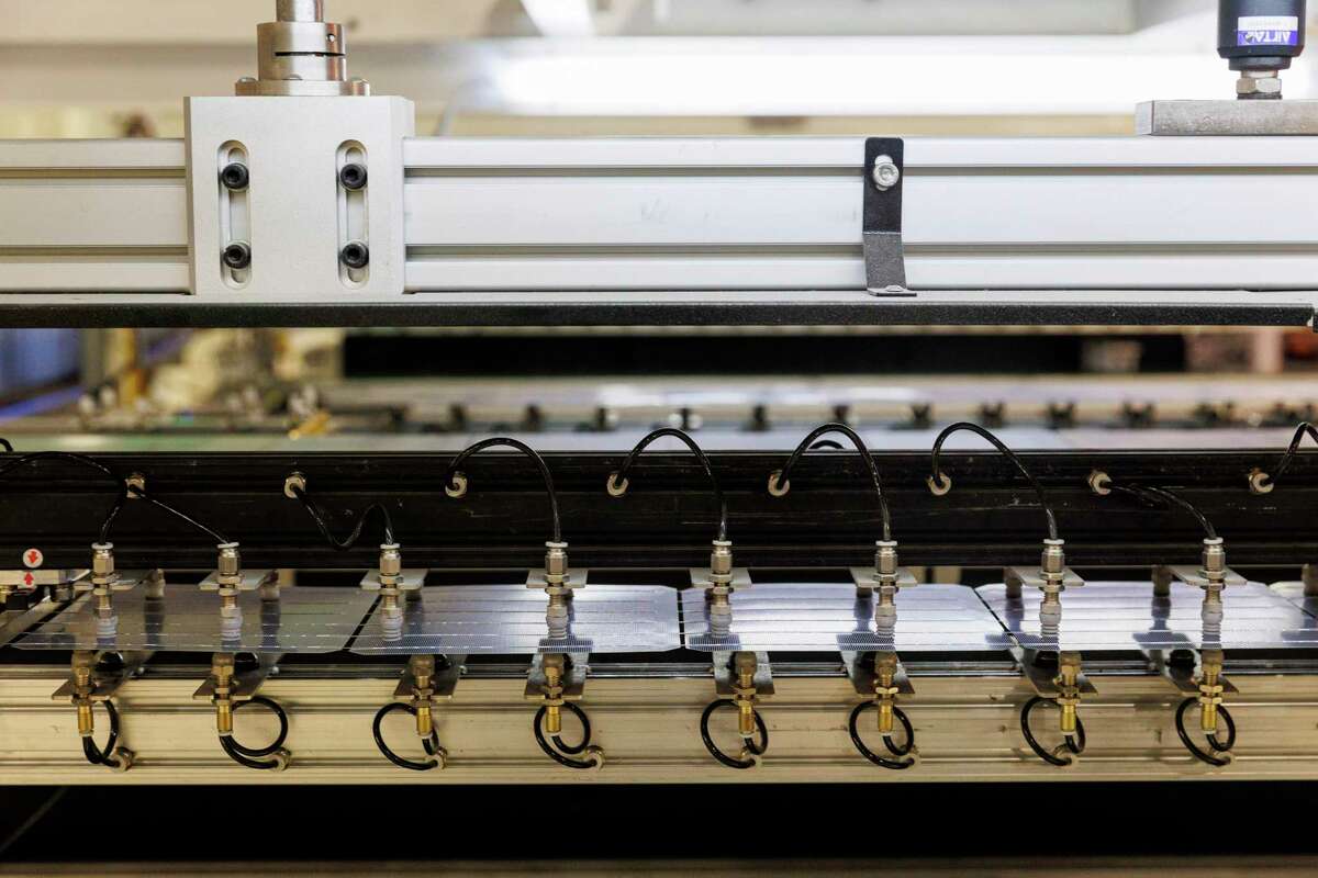 A row of solar cell are put through the stringer machine at Mission Solar Energy’s manufacturing facility on the South Side. Mission Solar sources most of its components and raw materials from Asian countries — such as Taiwan, Vietnam and Malaysia — to make solar panels at its San Antonio facility.