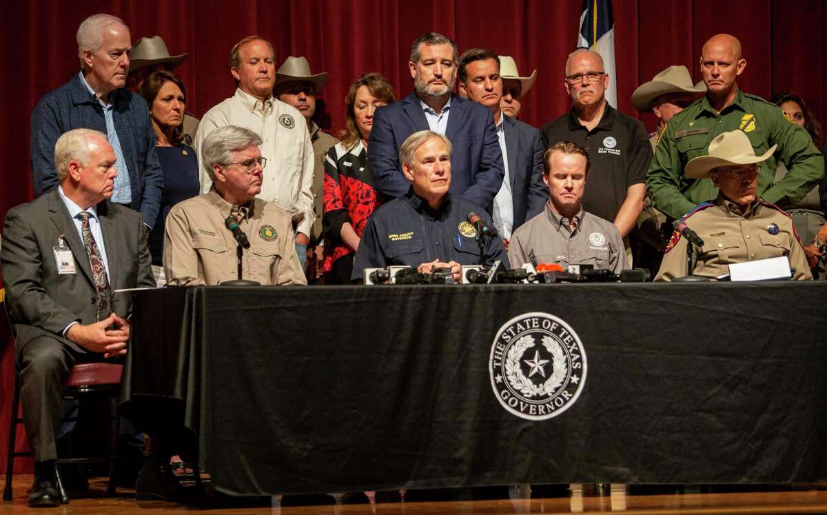 Gov. Greg Abbott, center, holds a press conference Wednesday May 25, 2022 in Uvalde, Texas to discuss the elementary school shooting that happened Tuesday where authorities say Salvador Rolando Ramos, 18, opened fire in a 4th grade classroom at Robb Elementary School killing 19 children and two teachers.