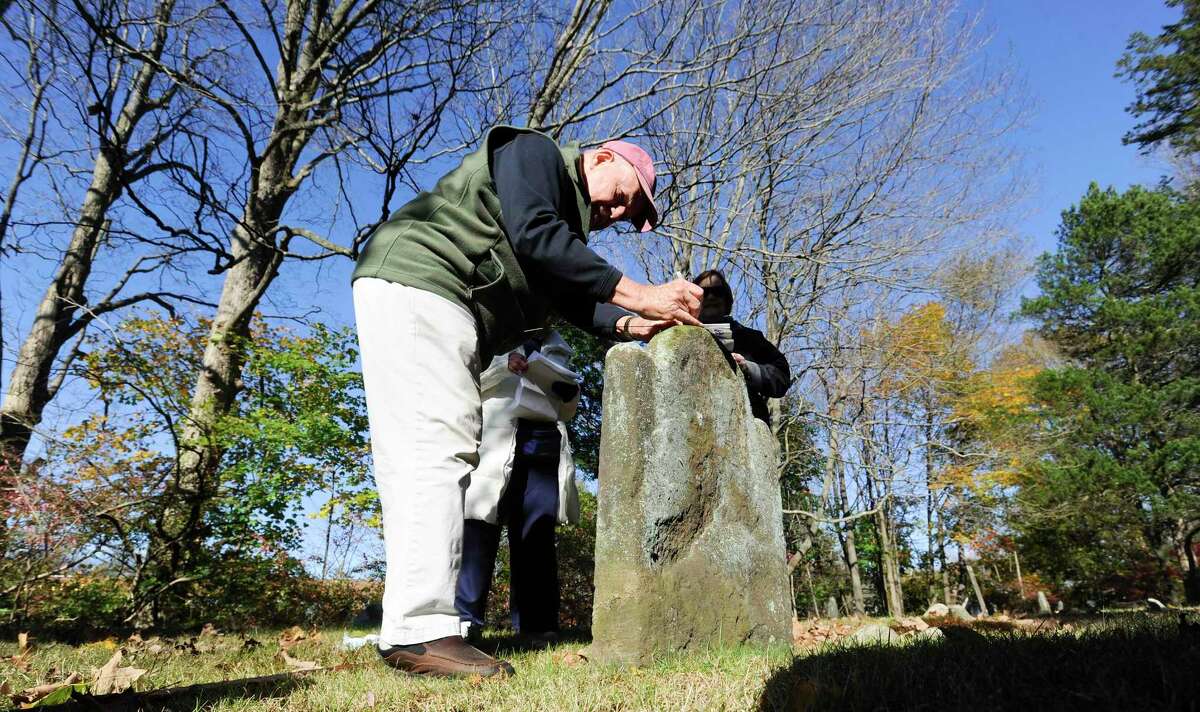 Wilton town historian Bob Russell use a gravestone to write notes prior to the Spirits of the Past cemetery walk and re-enactment at Sharp Hill Cemetery in Wilton, Conn. on Nov. 2, 2019. The event attended by three dozen area residents and sponsored by the Wilton Historical Society and Wilton Congregational Church, Sharp Hill is the oldest surviving cemetery in Wilton, dating back to 1738 when John Marvin gave a small parcel of land to the Congregational Society of Wilton as a site for a meeting house.