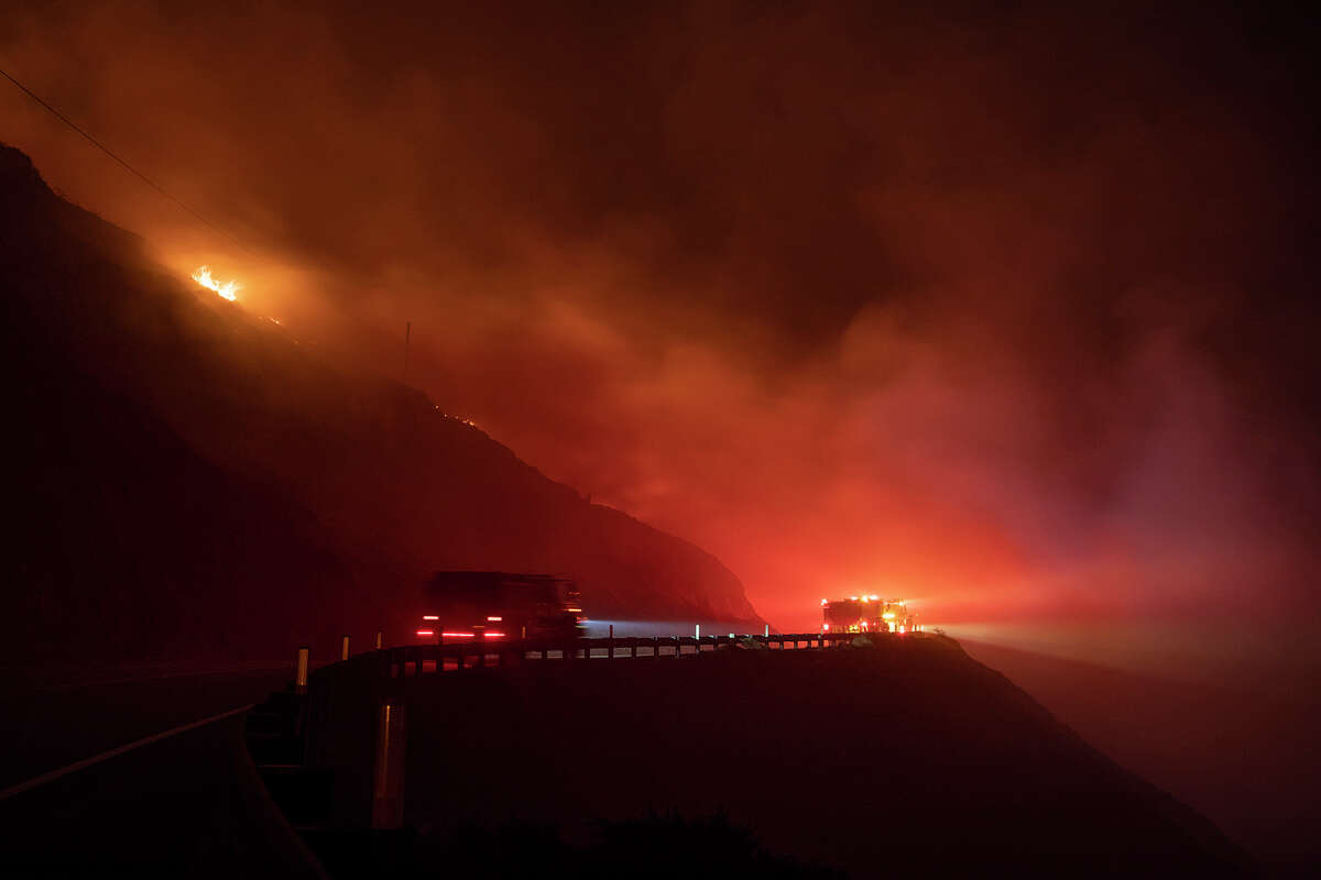 Fire burns above Highway 1 north of Big Sur, early Saturday morning, Jan. 22, 2022. The fire centered around the Palo Colorado Road neighborhood and was started by someone who doing a small pile burn, investigators said. High winds and dry conditions spread the blaze, which took almost two weeks to contain.