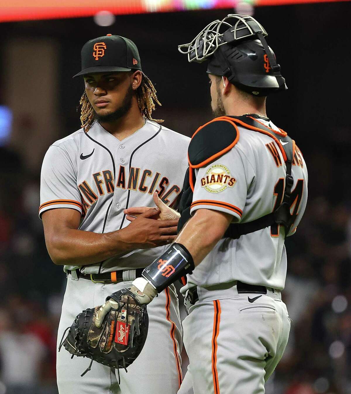 ATLANTA, GEORGIA - JUNE 21: Camilo Doval #75 and Austin Wynns #14 of the San Francisco Giants react after their 12-10 win over the Atlanta Braves at Truist Park on June 21, 2022 in Atlanta, Georgia. (Photo by Kevin C. Cox/Getty Images)