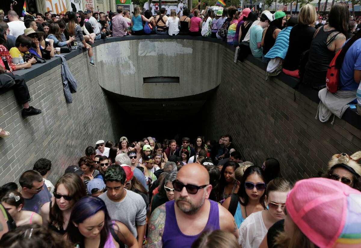 A crowd walks up the stairs of the Civic Center BART Station during the San Francisco Pride Parade in 2015. The parade, which takes place Sunday, is expected to draw a large crowd.