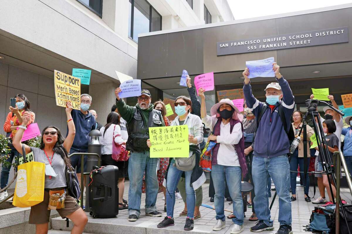 Supporters of a merit-based admission system rally before a special meeting at SFUSD headquarters on Wednesday in San Francisco.