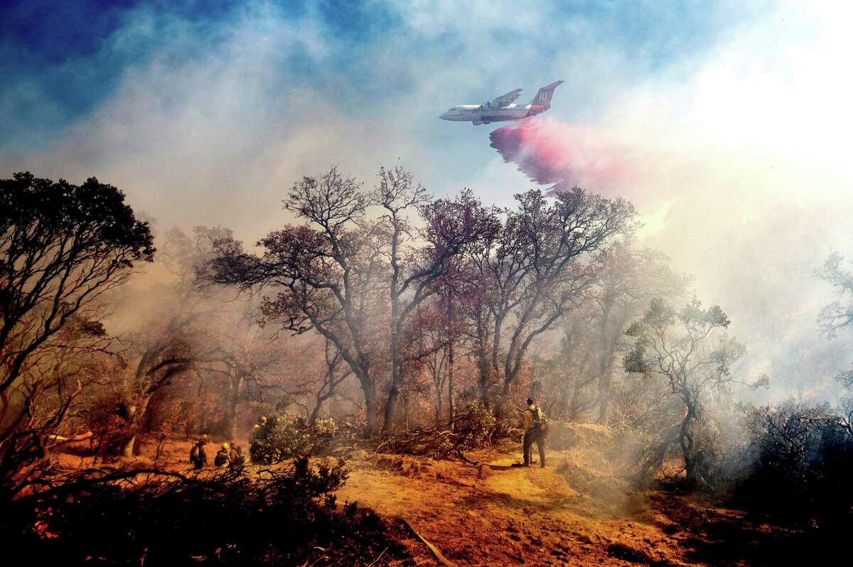 An air tanker drops retardant on the Olinda Fire burning in Anderson (Shasta County) in October 2020. The fire was one of thousands that made the 2020 wildfire season the worst on record in California.