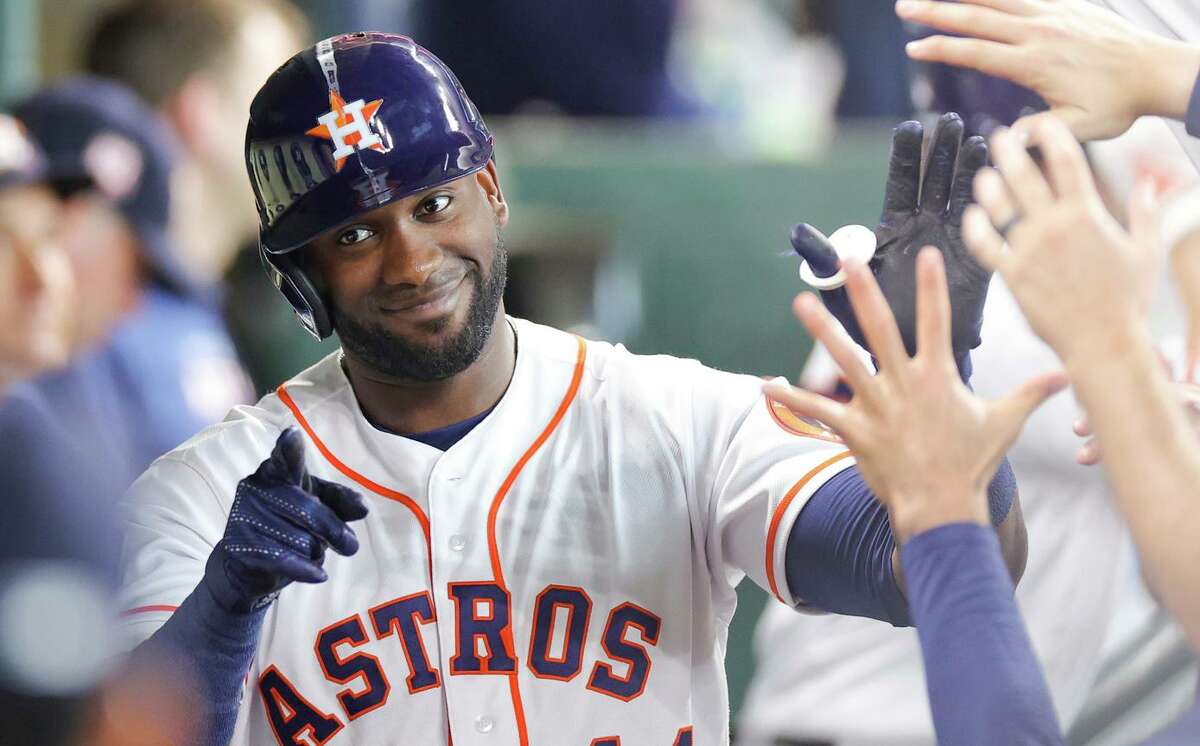 Houston’s Yordan Alvarez high-fives teammates after hitting a third-inning home run.