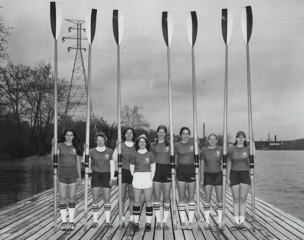 Yale's 1976 varsity women's crew team. Chris Ernst, then-captain and one of the initial organizers of the 1976 strip-in protest, is featured second to left. Ginny Gilder is not pictured.
