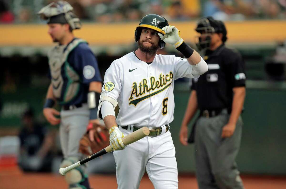 Jed Lowrie (8) walks back to the dugout after striking out in the second inning as the Oakland Athletics played the Seattle Mariners at the Coliseum in Oakland, Calif., on Wednesday, June 22, 2022.