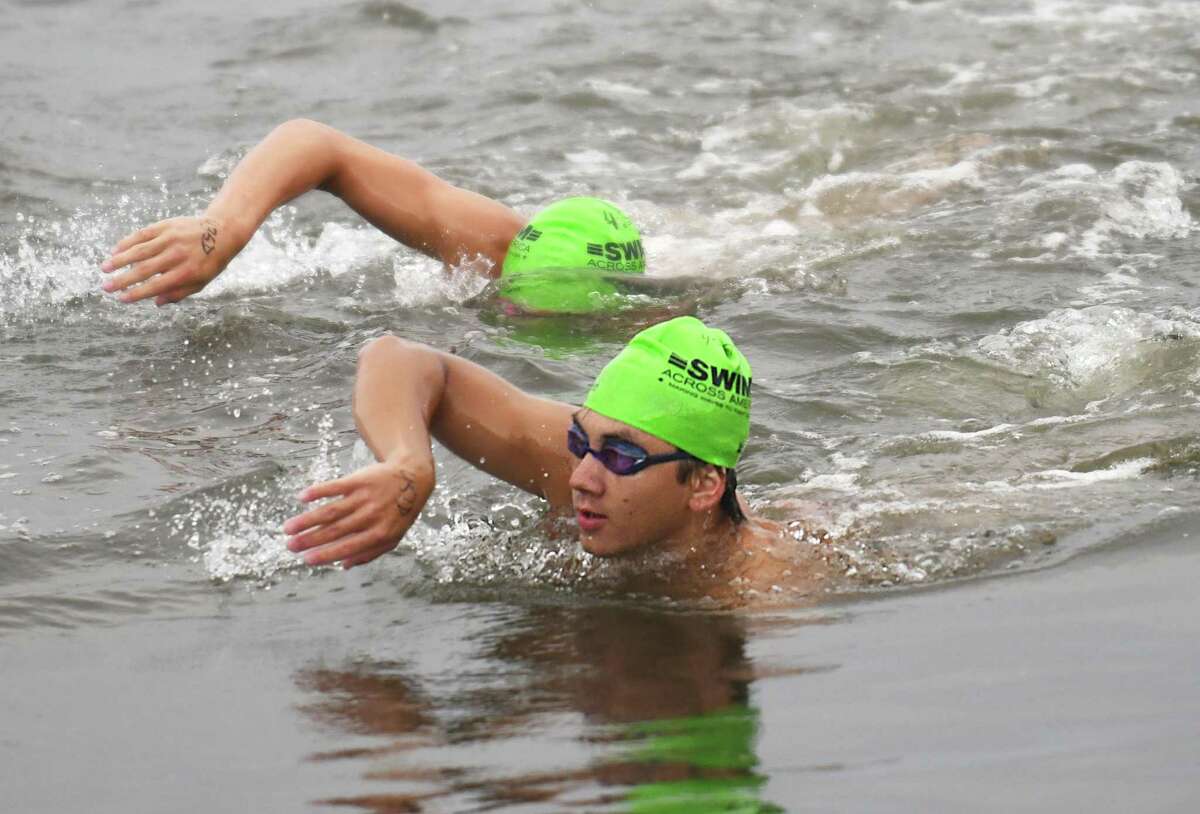Greenwich's Ryan Gee swims to the finish line at the Swim Across America Fairfield County event at Cummings Point in Stamford, Conn. Sunday, Aug. 8, 2021. More than $360,000 was raised at the event for the Alliance for Cancer Gene Therapy, a local nonprofit that funds research in cell and gene therapies to treat cancer. Swimmers swam routes ranging from half a mile to three miles as hundreds cheered them on from the shore.