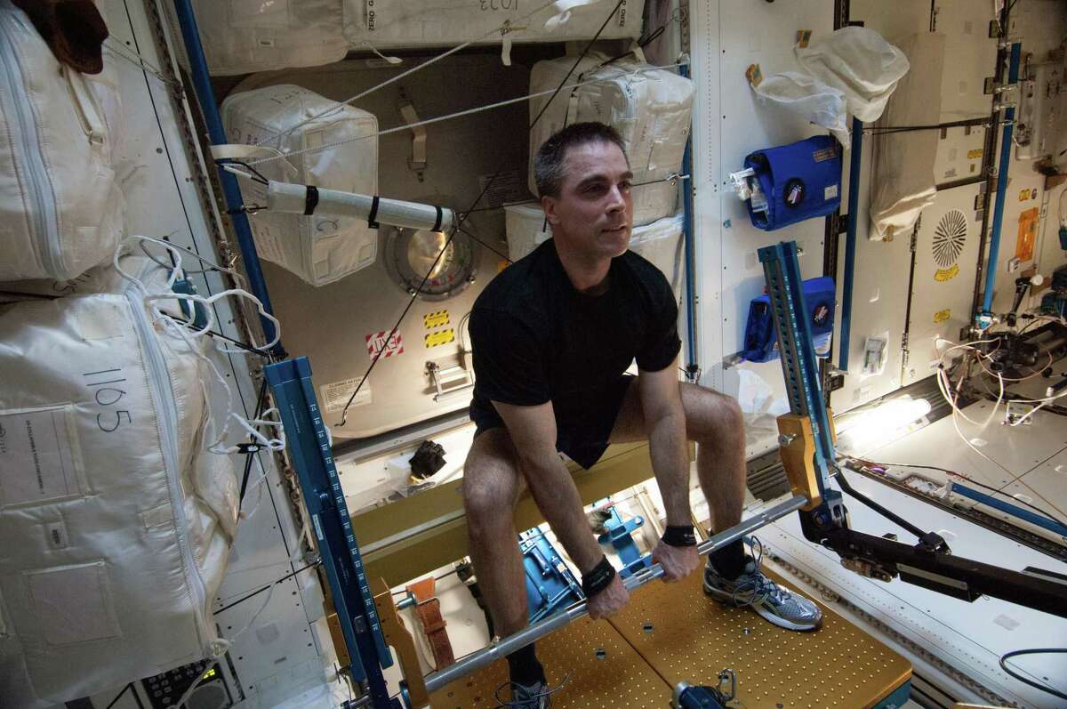 In this Aug. 31, 2013 photo made available by NASA, astronaut Chris Cassidy exercises on the advanced Resistive Exercise Device (aRED) in the Tranquility node of the International Space Station. (NASA via AP)