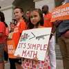 Elise Schering, 7, displays a message during a National Gun Violence Awareness Day rally at the Capitol in Sacramento, Calif., on June 2, 2022.
