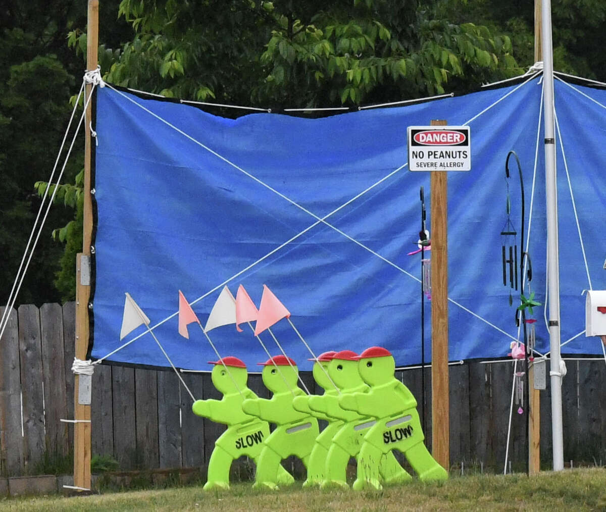 A blue tarp fence was erected between two homes on Van Ryn Avenue after neighbors got into a dispute on Thursday, June 23, 2022, in Schenectady, N.Y. Neighbors, tired of the ugly situation, wanted the city to do something but the city says there is little that can be done.