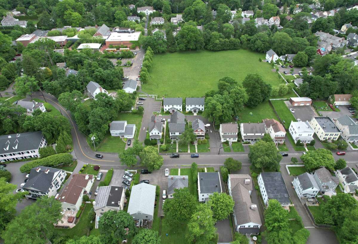 A stretch of houses on Northfield Street, six of which are owned by Brunswick School, near the Brunswick campus, top left, in Greenwich, Conn. Wednesday, June 1, 2022. The Greenwich tax assessor and Board of Estimate and Taxation have deemed various properties owned by Brunswick School near its Maher Avenue campus to be taxable, a change from recent years. The school has filed a lawsuit over it.