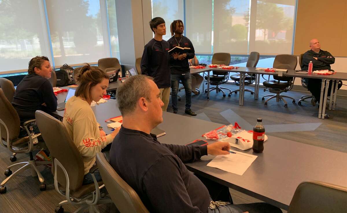 Students Dallas Le, left and Jonathan Martin, right, give a presentation to a panel of ExxonMobil, Beaumont ISD and Lamar University representatives to conclude their two-week 409 Energy Scholars program. Photo taken June 23, 2022. Photo by Olivia Malick/The Enterprise
