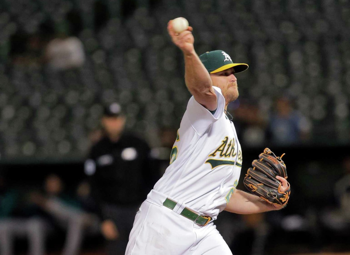 Sheldon Neuse (26) pitches for the A’s in the ninth inning as the Oakland Athletics played the Seattle Mariners at the Coliseum in Oakland, Calif., on Wednesday, June 22, 2022.