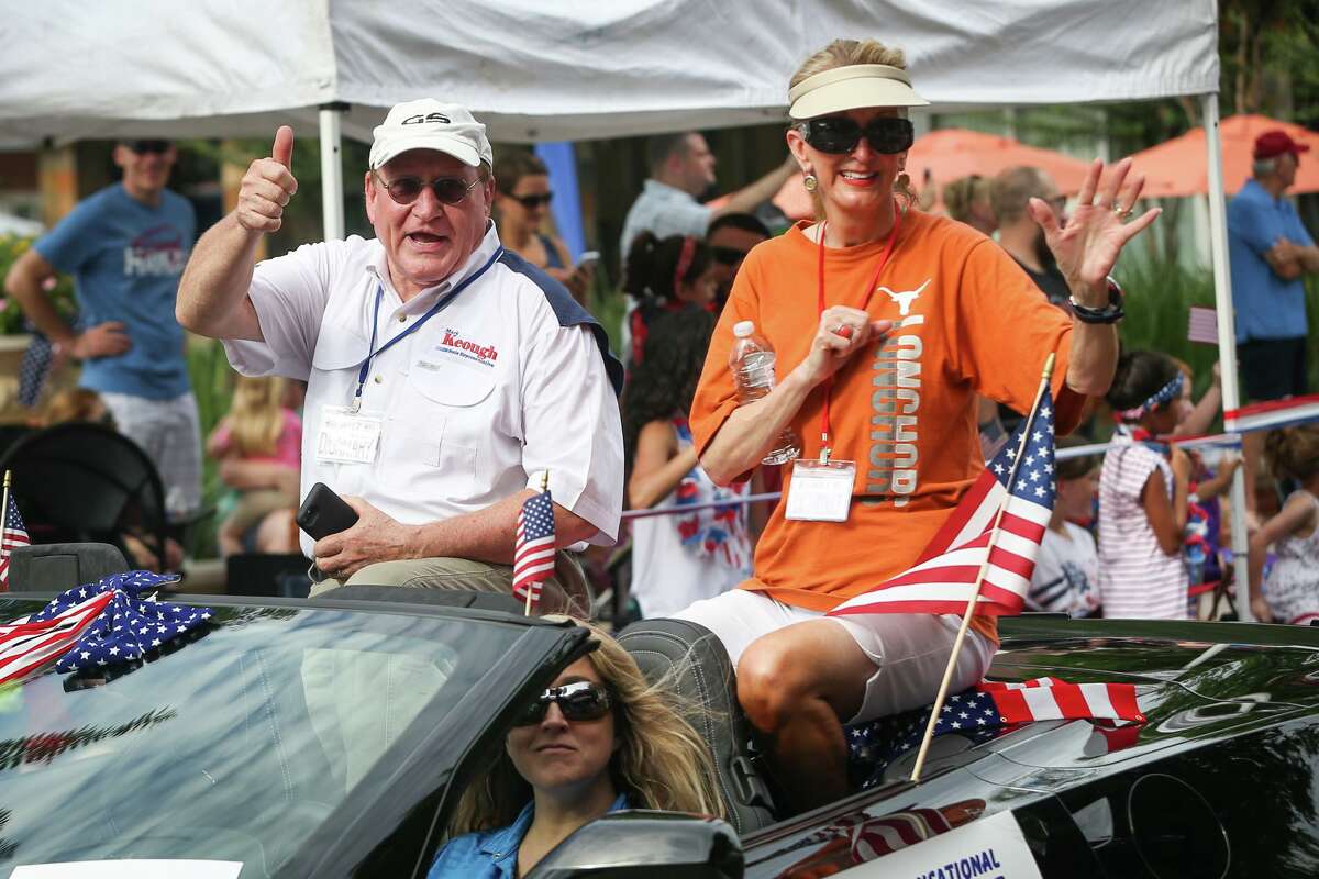 In this 2017 file photo, Montgomery County Judge Mark Keough, then a state representative, and his wife, Kimberly Sparks Keough, wave to attendees of the South County Fourth of July Parade at Market Street in The Woodlands. Mark Keough confirmed that his wife is the person referred to in a probable cause affidavit as been having been defrauded of $30,000.