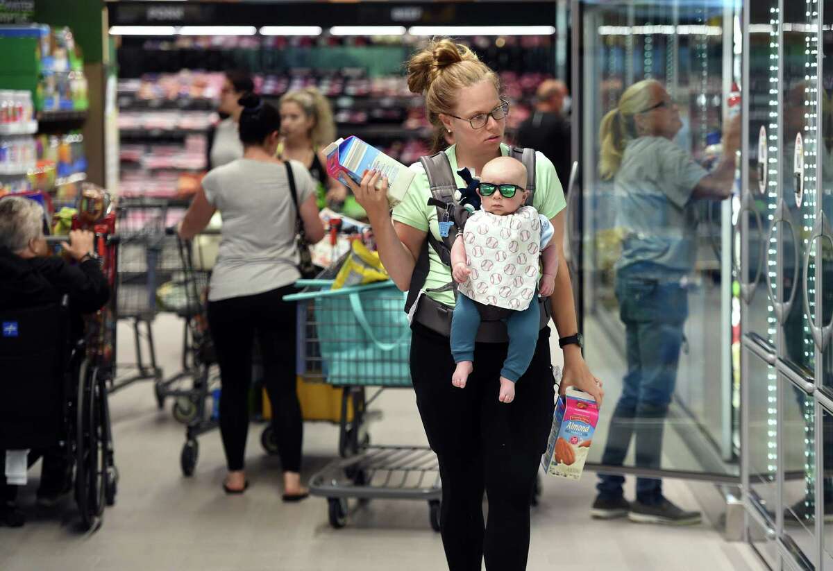 Kim Ainsley of Madison shops with her 4-month-old son, Wyatt, at the newly opened Aldi grocery store in Branford on June 23, 2022.