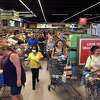 Shoppers browse in the produce aisle and wait in line to check out at the newly opened Aldi grocery store in Branford on June 23, 2022.
