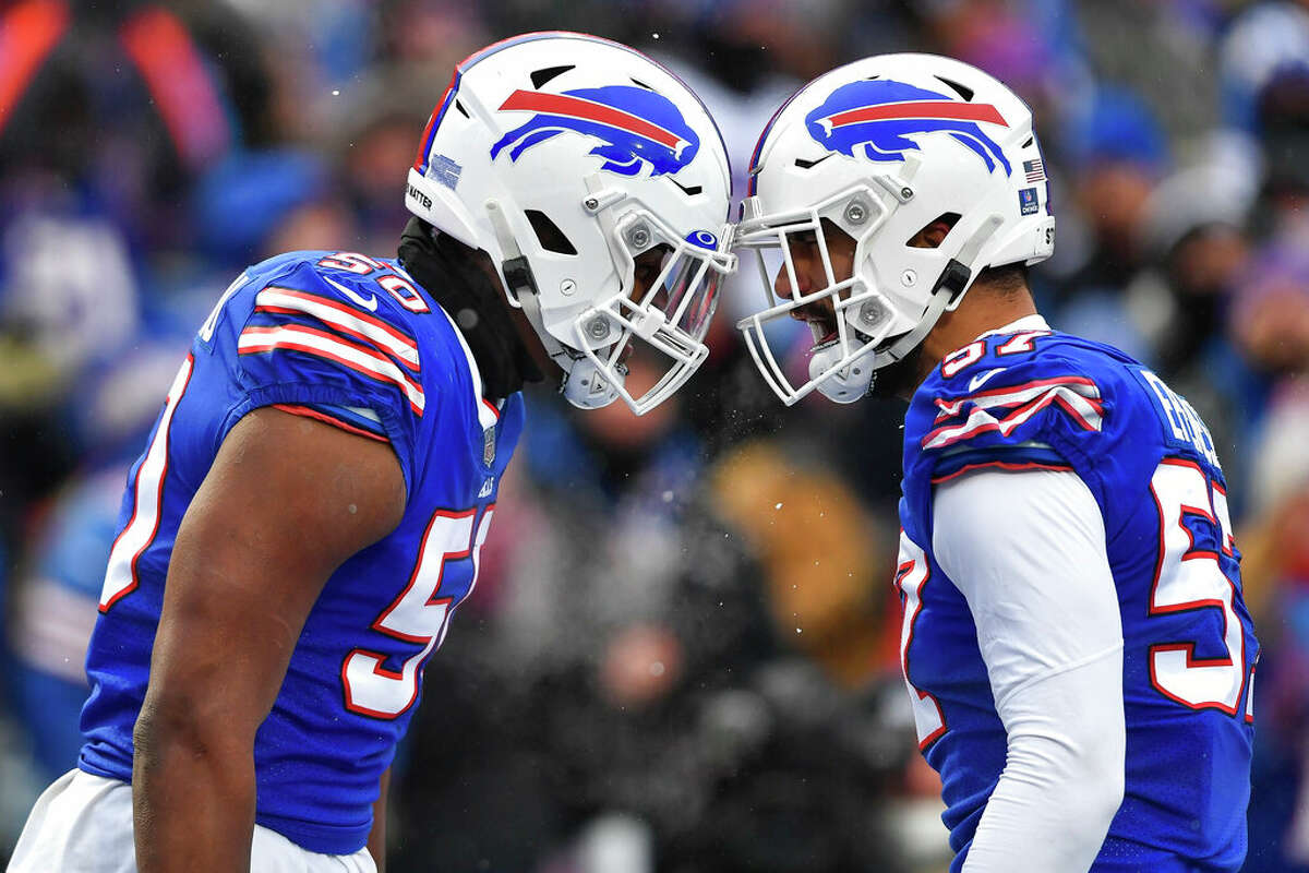 Buffalo Bills defensive end Greg Rousseau, left, and defensive end A.J. Epenesa celebrate a defensive stop during the first half of an NFL football game against the Atlanta Falcons in Orchard Park, N.Y., Sunday, Jan. 2, 2022.
